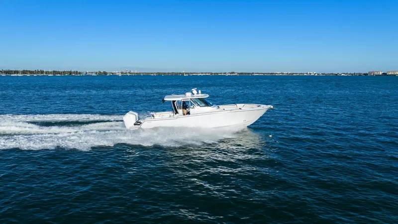  Yacht Photos Pics Bertram 39 CC 2023 cruising on open sea under clear sky.