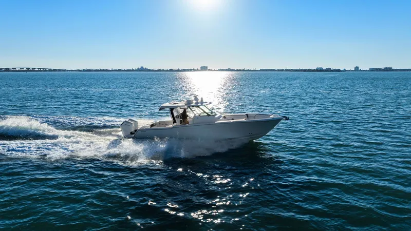  Yacht Photos Pics Bertram 39 CC 2023 cruising on the sea at sunset.