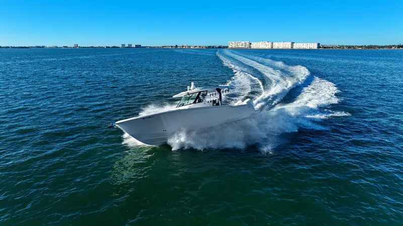  Yacht Photos Pics Bertram 39 CC 2023 cruising swiftly on open sea.