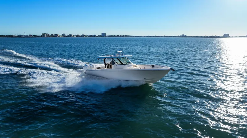  Yacht Photos Pics Bertram 39 CC 2023 cruising swiftly on open water.