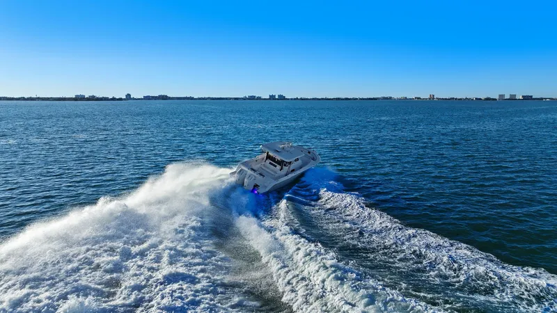  Yacht Photos Pics Bertram 39 CC 2023 cruising swiftly on open sea.