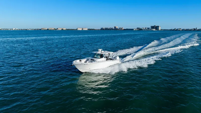  Yacht Photos Pics Bertram 39 CC 2023 boat cruising on open sea under clear sky.