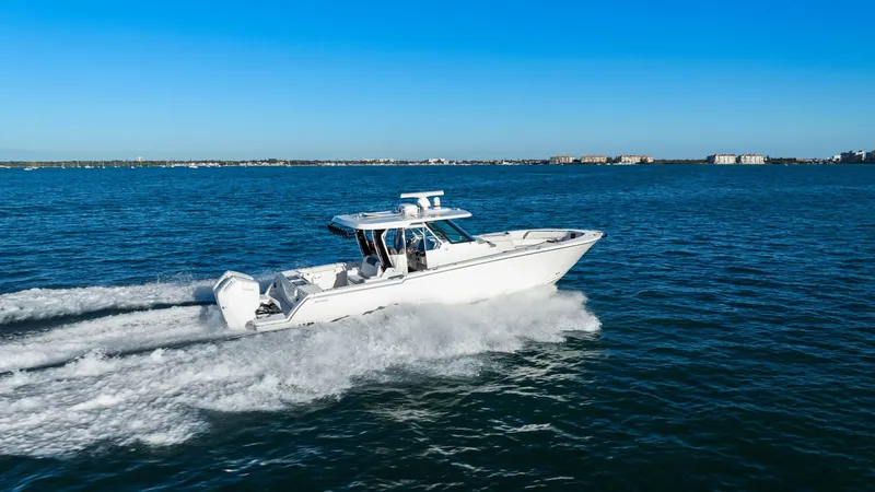  Yacht Photos Pics 2023 Bertram 39 CC boat cruising on the sea under clear skies.