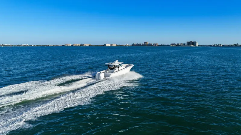  Yacht Photos Pics Bertram 39 CC 2023 cruising swiftly on open water.