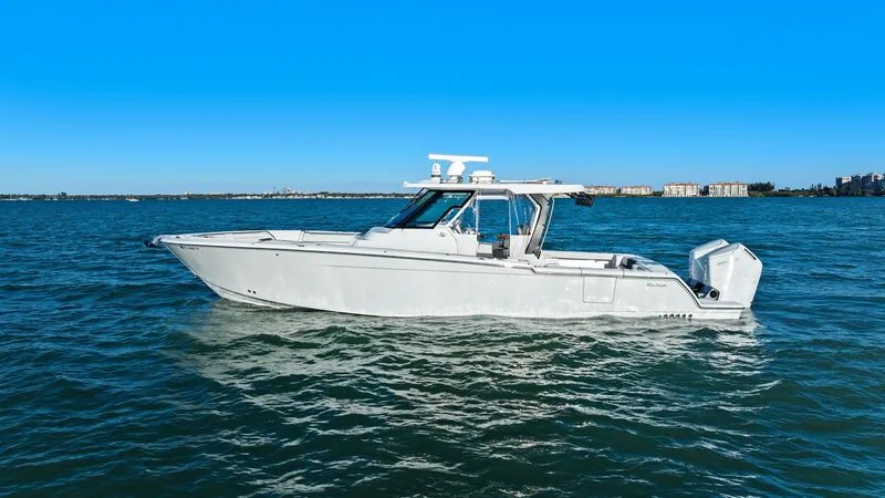  Yacht Photos Pics 2023 Bertram 39 CC boat on calm water under clear sky.
