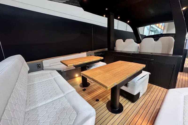 Max 43 Comfort Yacht Photos Pics Luxurious interior of 2025 Maxim Yachts 43 Comfort, featuring elegant seating and wooden tables.