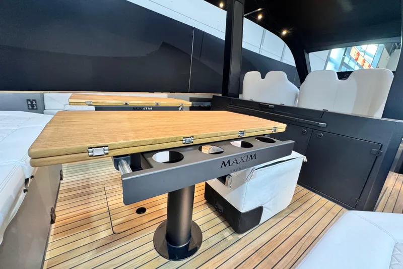 Max 43 Comfort Yacht Photos Pics Luxurious interior of 2025 Maxim Yachts 43 Comfort, featuring elegant wood table and seating.