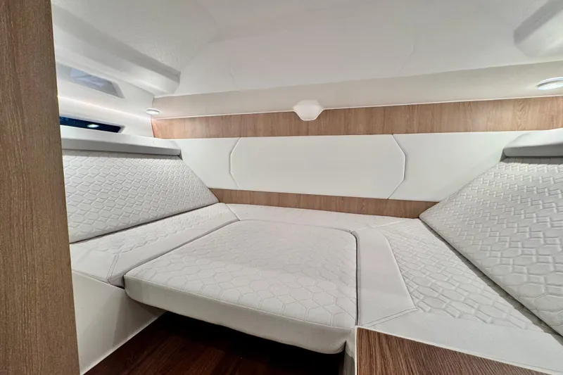 Max 43 Comfort Yacht Photos Pics Luxurious interior of 2025 Maxim Yachts 43 Comfort, featuring elegant bedding and wood accents.