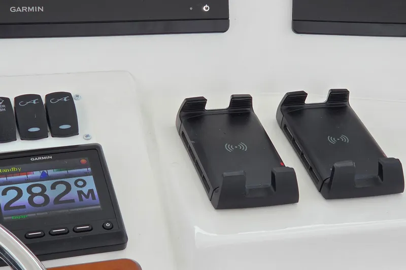 Salty Bear Yacht Photos Pics Control panel of 2022 Albemarle 36 Express with Garmin display and wireless charging docks.