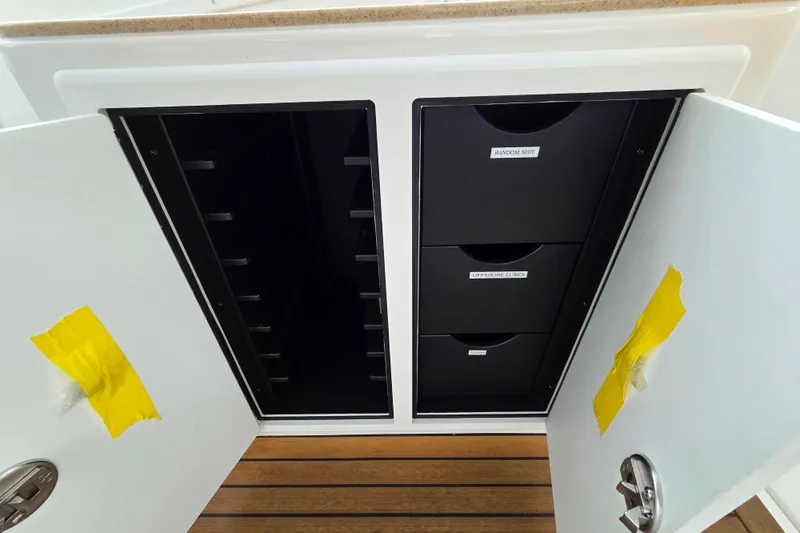 Salty Bear Yacht Photos Pics Open storage cabinet on 2022 Albemarle 36 Express boat with labeled drawers.