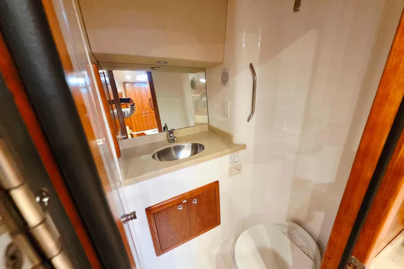 Salty Bear Yacht Photos Pics 2022 Albemarle 36 Express bathroom with sink, mirror, and toilet.