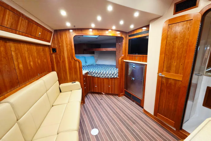 Salty Bear Yacht Photos Pics Luxurious interior of 2022 Albemarle 36 Express yacht with wood finish and cozy seating.