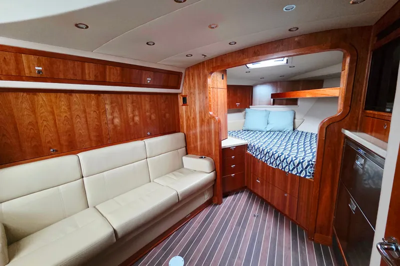 Salty Bear Yacht Photos Pics Luxurious interior of 2022 Albemarle 36 Express yacht with wood finish and cozy seating.