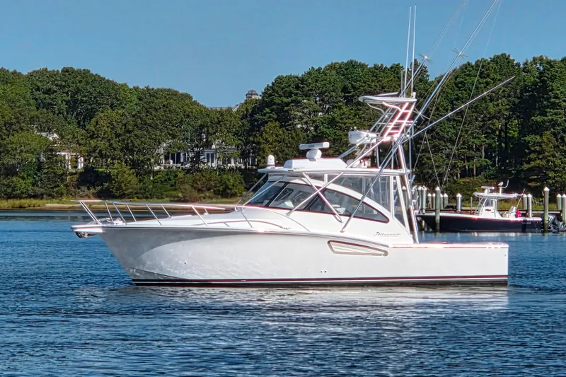 Salty Bear Yacht Photos Pics 2022 Albemarle 36 Express boat on calm water with lush green trees in the background.