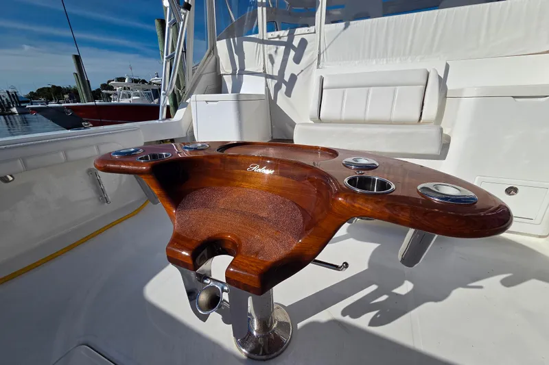 Salty Bear Yacht Photos Pics 2022 Albemarle 36 Express boat cockpit with polished wood table and cup holders.
