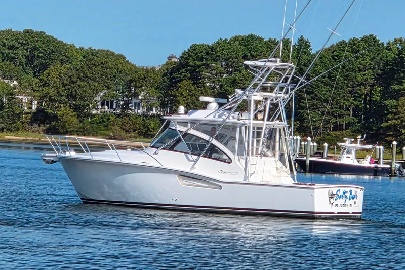 Salty Bear Yacht Photos Pics 2022 Albemarle 36 Express boat on calm water, surrounded by lush greenery.