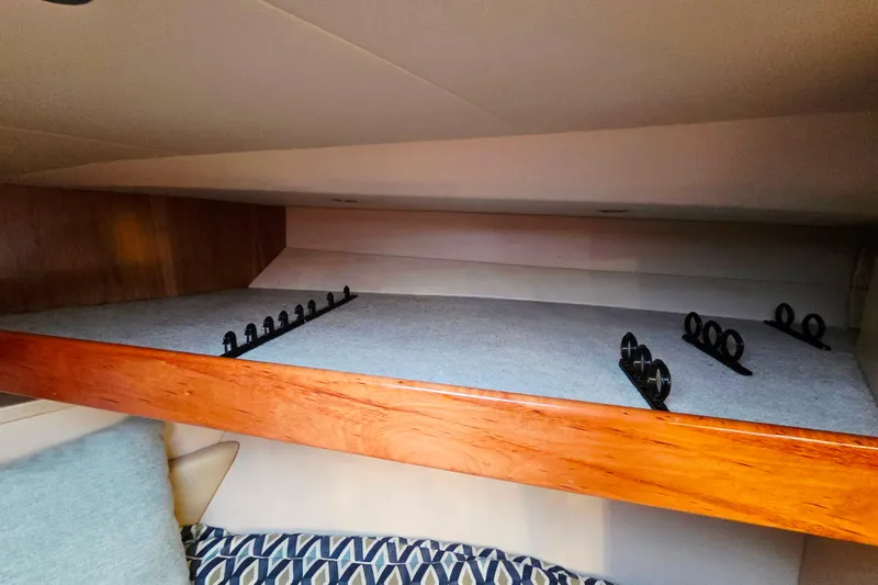 Salty Bear Yacht Photos Pics 2022 Albemarle 36 Express interior with rod storage and wooden accents.