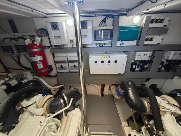  Yacht Photos Pics Engine room of 2021 Monte Carlo MC6 yacht with equipment and fire extinguisher.