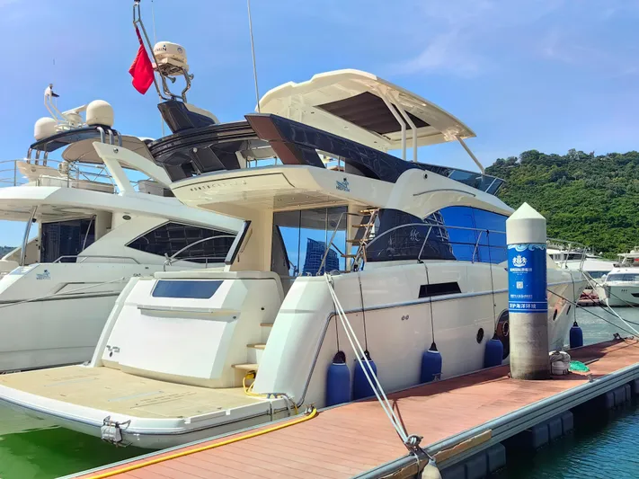  Yacht Photos Pics Luxury Monte Carlo MC6 yacht docked at marina, 2021 model, with clear blue sky.