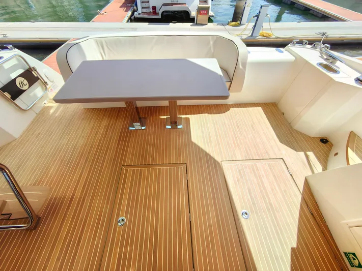  Yacht Photos Pics Luxurious Monte Carlo MC6 2021 yacht deck with seating and table, docked at marina.