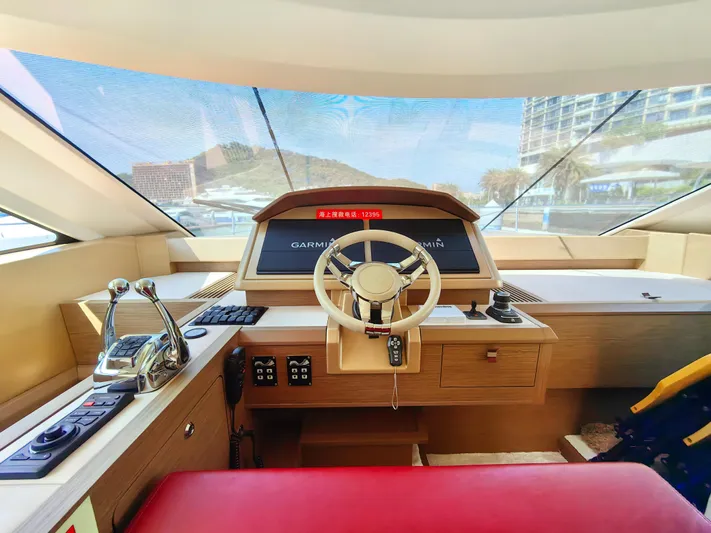  Yacht Photos Pics Interior view of 2021 Monte Carlo MC6 yacht cockpit with modern controls and steering wheel.