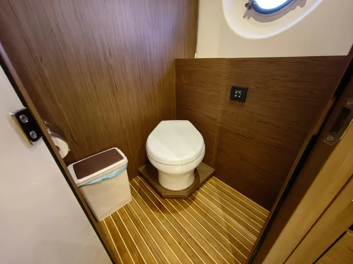  Yacht Photos Pics Luxurious Monte Carlo MC6 2021 yacht bathroom with wood paneling and modern fixtures.