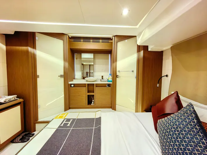  Yacht Photos Pics Luxurious Monte Carlo MC6 2021 yacht bedroom with modern wood accents and elegant bedding.