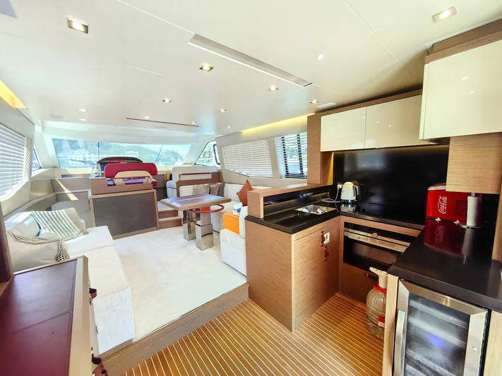  Yacht Photos Pics Luxurious interior of 2021 Monte Carlo MC6 yacht with modern kitchen and seating area.