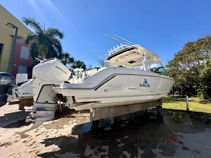  Yacht Photos Pics 2024 Boston Whaler 320 Vantage boat on a dock in sunny weather.