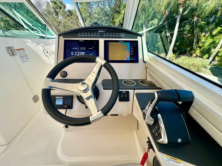  Yacht Photos Pics Interior view of 2024 Boston Whaler 320 Vantage cockpit with controls.