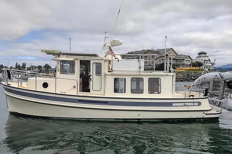 Bernardi Yacht Photos Pics 2004 Nordic Tug 32 boat docked in a marina with cloudy skies.
