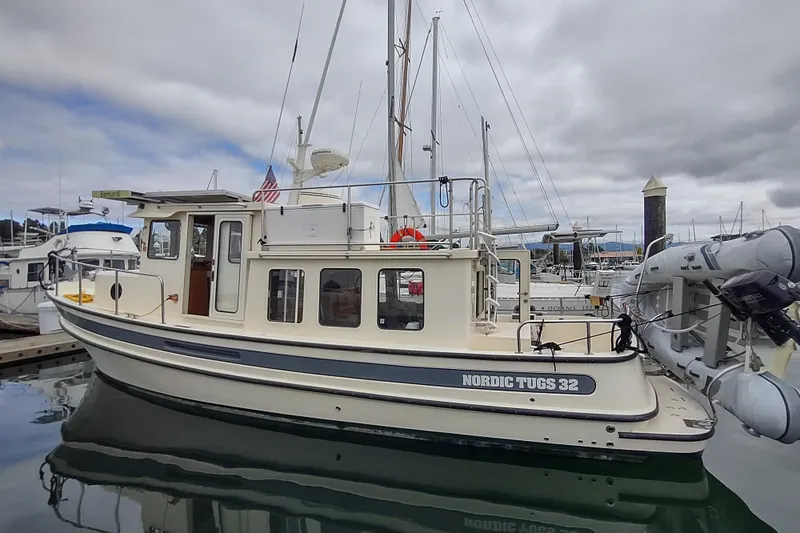 Bernardi Yacht Photos Pics 2004 Nordic Tug 32 docked at marina, featuring classic design and sturdy build.