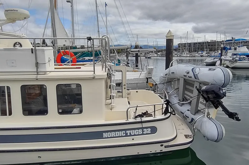 Bernardi Yacht Photos Pics 2004 Nordic Tug 32 docked at marina with inflatable boat attached.