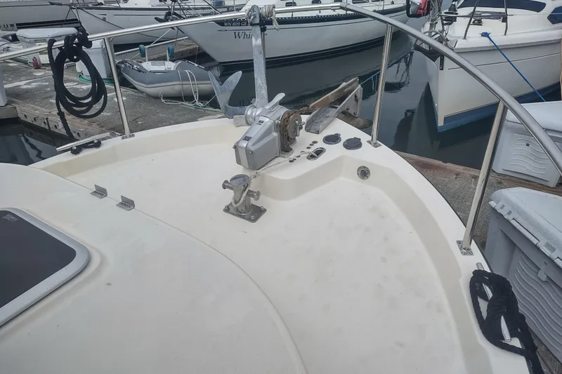 Bernardi Yacht Photos Pics Nordic Tug 32 (2004) bow with anchor and railing at marina.