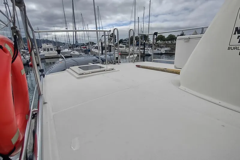 Bernardi Yacht Photos Pics 2004 Nordic Tug 32 docked in marina, featuring spacious deck and life rings.