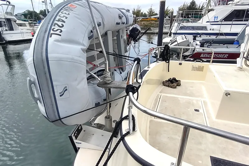 Bernardi Yacht Photos Pics 2004 Nordic Tug 32 with dinghy attached at marina dock.