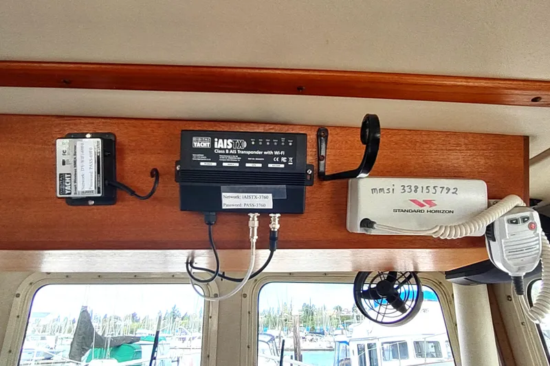 Bernardi Yacht Photos Pics Navigation equipment inside a 2004 Nordic Tug 32 boat, featuring communication devices and transponder.