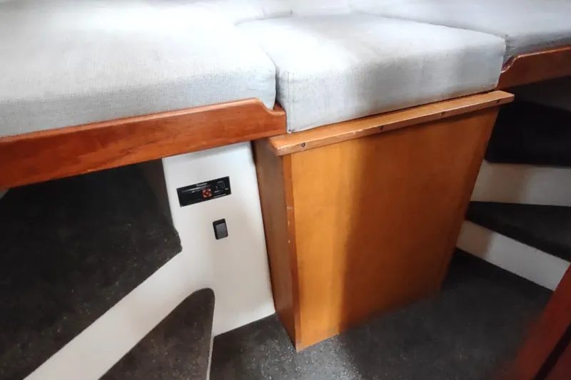 Bernardi Yacht Photos Pics 2004 Nordic Tug 32 interior with wooden cabinetry and cushioned seating.