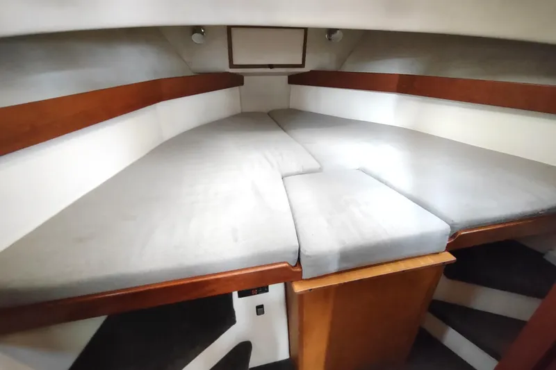 Bernardi Yacht Photos Pics 2004 Nordic Tug 32 interior cabin with V-berth and wooden accents.