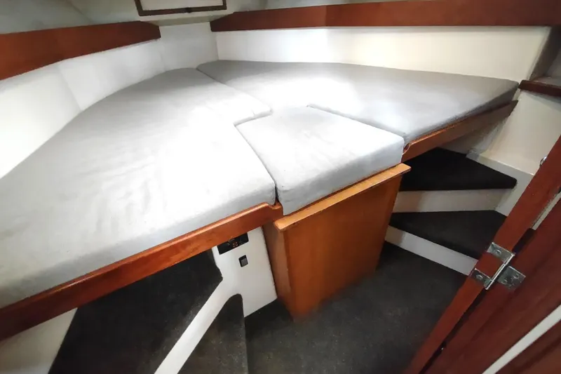 Bernardi Yacht Photos Pics 2004 Nordic Tug 32 interior cabin with V-berth and wooden accents.