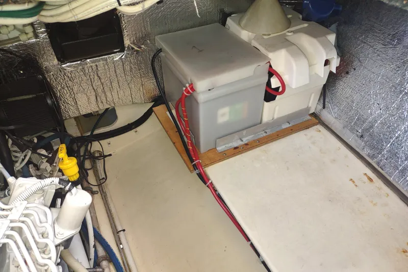 Bernardi Yacht Photos Pics Engine compartment of a 2004 Nordic Tug 32, featuring battery and wiring setup.