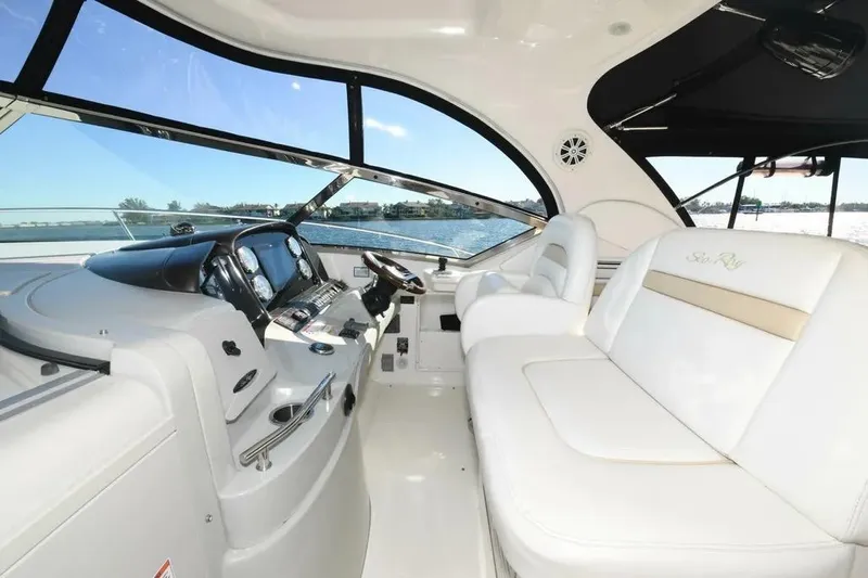  Yacht Photos Pics Luxurious interior of 2010 Sea Ray 390 Sundancer yacht with plush seating and modern dashboard.