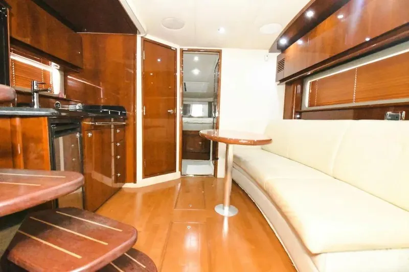  Yacht Photos Pics Luxurious interior of 2010 Sea Ray 390 Sundancer yacht with wood finishes and seating area.