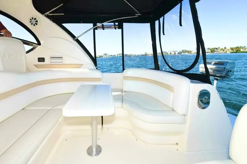 Yacht Photos Pics Luxurious interior of 2010 Sea Ray 390 Sundancer yacht with white seating and table.
