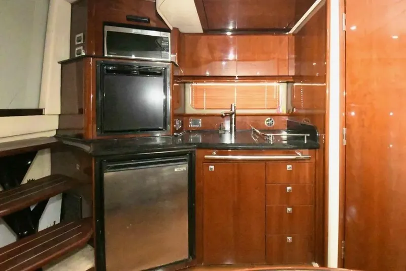  Yacht Photos Pics Luxurious 2010 Sea Ray 390 Sundancer yacht kitchen with modern appliances and wood cabinetry.