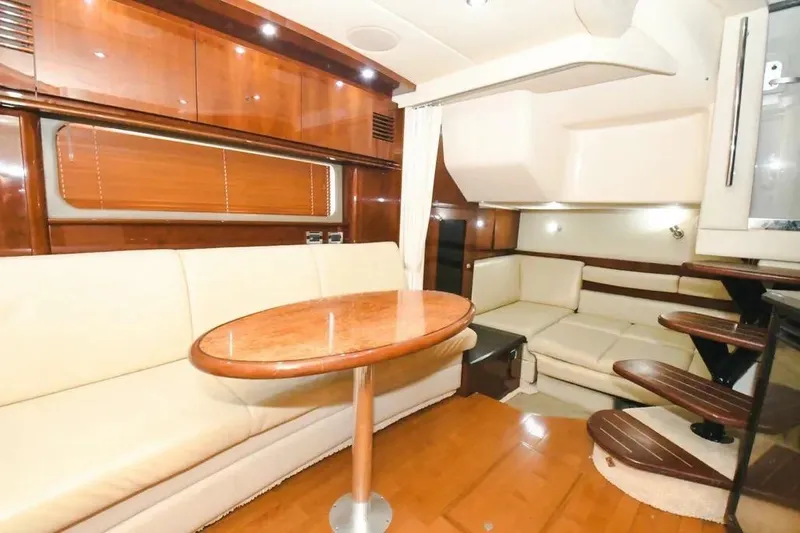  Yacht Photos Pics Luxurious interior of 2010 Sea Ray 390 Sundancer yacht with elegant seating and wooden finishes.
