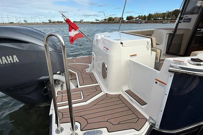  Yacht Photos Pics 2025 Ranger Tugs R-27 boat with Yamaha engine, docked with Canadian flag.