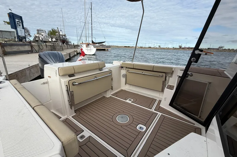  Yacht Photos Pics 2025 Ranger Tugs R-27 boat interior with seating, docked by the water.
