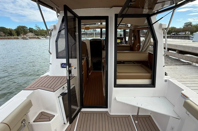  Yacht Photos Pics 2025 Ranger Tugs R-27 boat interior with open doors, dockside view.