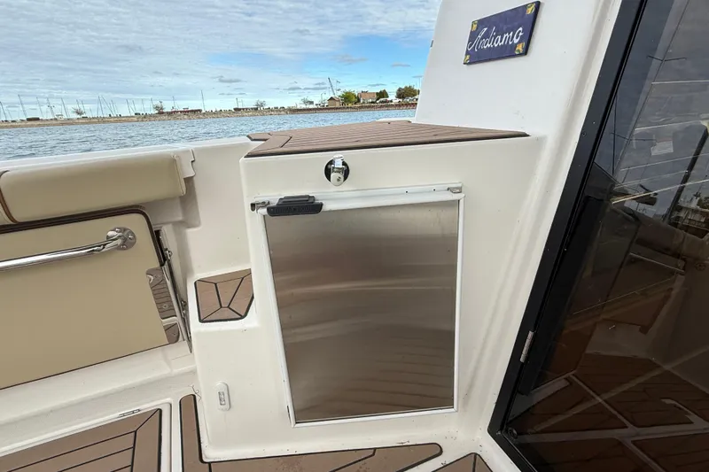  Yacht Photos Pics 2025 Ranger Tugs R-27 boat interior with stainless steel storage compartment and scenic water view.